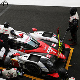 A mechanic is filling TS050 HYBRID #7 with petrol