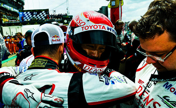 Kazuki Nakajima comforting sorrow and Sebastian Buemi