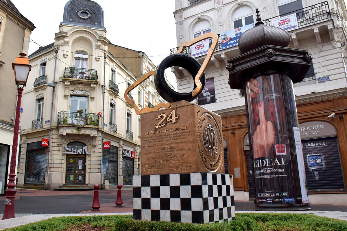 An art piece portraying the 24 Hours of Le Mans race placed in the town of Le Mans