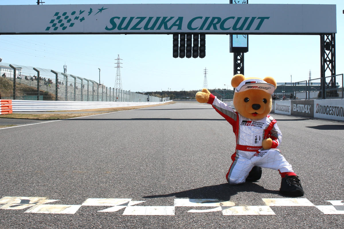鈴鹿サーキットのホームストレートで記念撮影するトヨタ くま吉